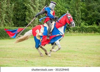 Medieval Knight Costume On A Horse And Man With Flag 