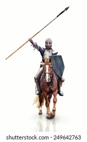 Medieval knight with the lance riding the horse. Focus point on the knight.