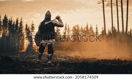 Medieval Knight Looking at Sunrise. Romantic Hero, Soldier, Warrior in Body Armour with Sword On a Journey to Safe Princess. Mysterious Smoke, Magic Forest and Adventure. Back View Shot
