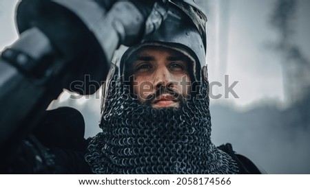 Medieval Knight on Battlefield, Looking at Camera, his Helmet is Open. Portrait of Mighty Warrior, King, Soldier at War, Conquest, Crusade. Dramatic Scene, Cinematic Historic Reenactment