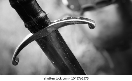 Medieval knight with sword in armor as style Game of Thrones in battle or tournament black and white old photo