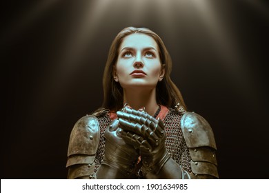 Medieval Knight Woman In Armor Prays, Blessing Before The Battle.