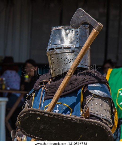 Medieval knights fighting with armor, swords\
and shields in\
festival	