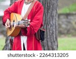 A medieval minstrel playing guitar during the annual 