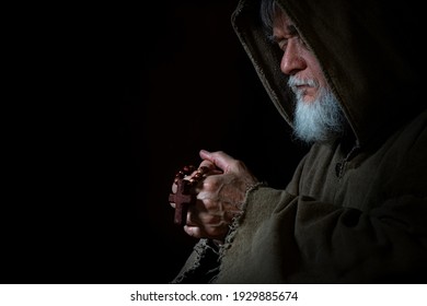 Medieval Monk Prays With Rosary