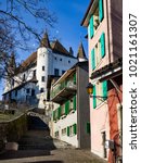 The medieval Nyon Castle in a sunny day, Nyon, Switzerland, 2018, january. White towers, blue sky