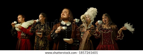 Medieval people as a royalty persons in vintage\
clothing drinking coffee, tea on dark background. Concept of\
comparison of eras, modernity and renaissance, baroque style.\
Creative collage.