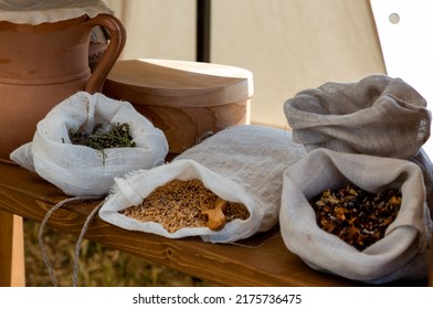 medieval reenactment - sacks with seeds and spices stored in a wooden shelf in a medieval market during a historical reenactment