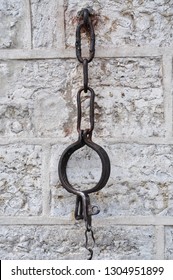 Medieval shackles mounted in old stone wall on Town Hall square in old Tallinn, Estonia - Image