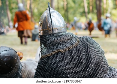 Medieval Soldier In Chain Mail Protection And Helmet Outdoors. Close-up, Back View.