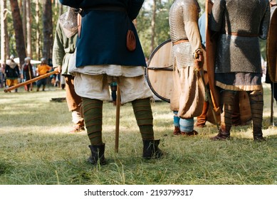 Medieval Soldiers Preparing For Battle On The Battlefield, Outdoor Historical Reenactment Festival. Close-up Of Legs, Low Angle View.