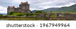 Medieval stone castle stronghold beautiful Scotland landscape wallpaper panoramic. Eilean Donan stone castle and bridge tourist attraction background