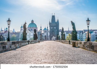 Medieval stone Charles bridge with statues of saints in a thin haze during early morning, Prague, Czech Republic