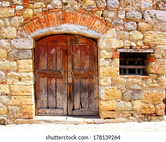 Medieval stone house with rustic door, Tuscany, Italy
