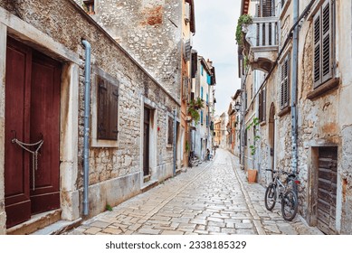 Medieval street in the city of Rovinj, old houses without restoration, pavement