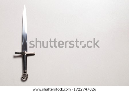 A Medieval Sword Isolated on a White Textured Background