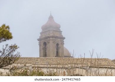 Medieval townscape with bell tower of church of San Giuliano on a foggy day, Erice, Sicily, Italy - Powered by Shutterstock