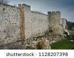 Medieval walls of Jerusalem. Ancient stone, gloomy sky. Gloomy walls of Jerusalem
