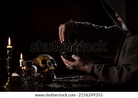 A medieval wizard mixes elixir.