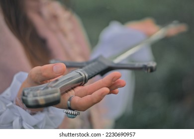 Medieval Woman's hands holding a sword closeup