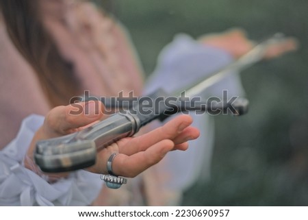 Medieval Woman's hands holding a sword closeup