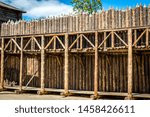 Medieval wooden fence made of palisade.