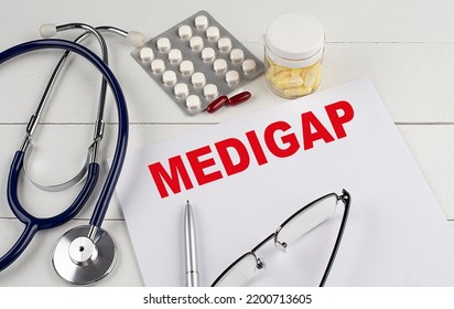 Medigap Word On A Paper With Stethoscope And Pills