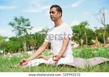 Meditating man in the park