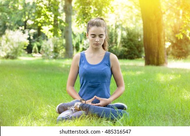 meditating teenage girl in a park