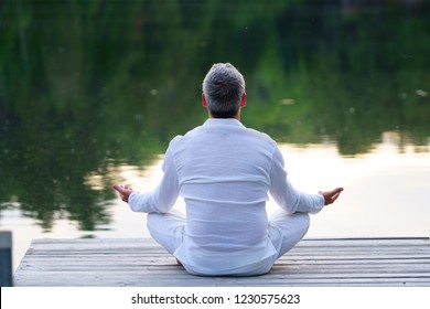 Meditation by the river at the sunset.                              