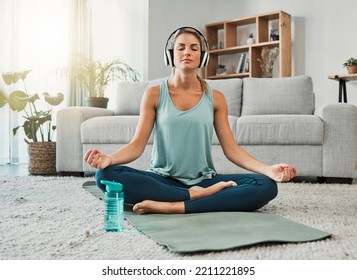 Meditation, Fitness And Headphones With Woman In Living Room Listening To Podcast, Audio Or Music To Relax. Wellness, Peace And Zen With Girl And Yoga In Home Gym For Health, Sports And Workout