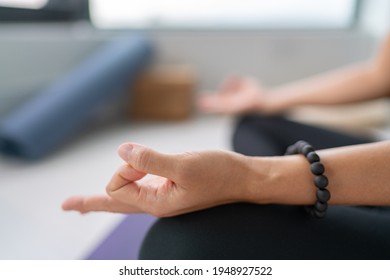 Meditation at home . Yoga woman in lotus pose closeup of hands vitarka mudra hand.