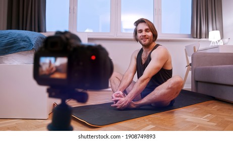 Meditation And Mental Health Concept. Young Man Practise Yoga Meditating And Streaming Online. High Quality Photo