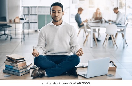 Meditation, relax or businessman with laptop, books or zen peace in office desk for work mindset, wellness or mental health. Corporate, employee or Asian man relaxing, meditating or lotus pose - Powered by Shutterstock