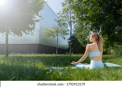 Meditation Yoga. Woman In The Park Among Trees And Greenery