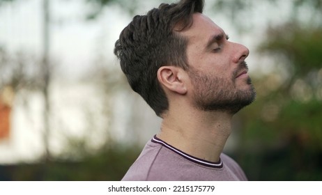 Meditative Man Standing Outdoors Opening Eyes To Sky Feeling FREE. Contemplative Person Breathing Outside