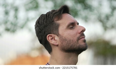 Meditative Man Standing Outdoors Opening Eyes To Sky Feeling FREE. Contemplative Person Breathing Outside