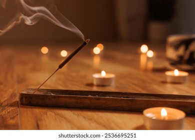 Meditative moment with incense and candles, smoking aromatic incense stick close up. aromatherapy - Powered by Shutterstock