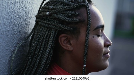 Meditative Young Woman Eyes Closed Relaxing Outside. A Pensive Hispanic Black Brazilian With Restul Peace Of Mind