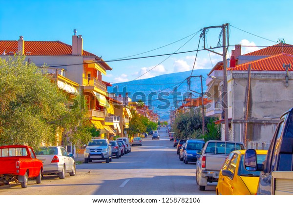 Mediterranean buildings\
street cars road 
