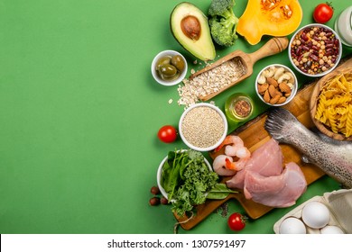 Mediterranean diet concept - meat, fish, fruits and vegetables on bright green background - Shutterstock ID 1307591497