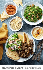 Mediterranean Food On The Table, Gyro Platter, Pita And Dips And Tabbouleh