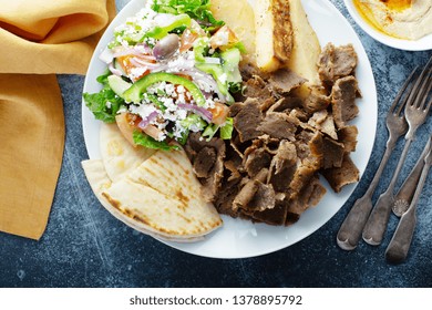 Mediterranean Food On The Table, Gyro Platter, Pita And Dips And Tabbouleh