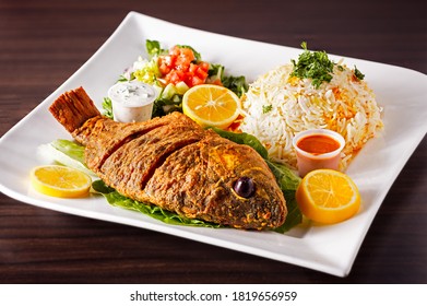 Mediterranean Fried Tilapia Fish Entree With Rice And Salad