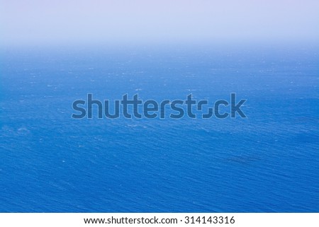 Mediterranean ocean  with seafoam on a sunny windy day in Mallorca, Balearic islands, Spain in July.