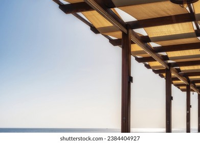Mediterranean roof construction to provide shade with free text space in the sky - Shutterstock ID 2384404927