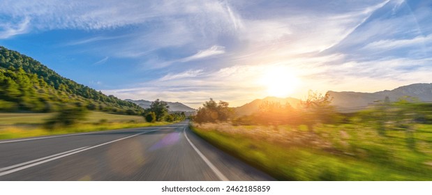 Mediterranean sea coast road into mountains horizon in summer with beautiful bright sun rays - wide angle panorama shot with high speed motion blur effect - Powered by Shutterstock