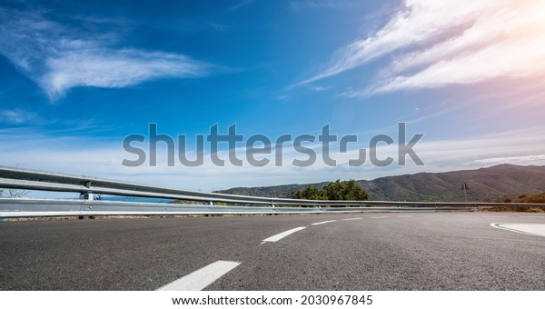 Mediterranean\
sea coast road into mountains horizon in summer with beautiful\
bright sun rays - wide angle panorama\
shot