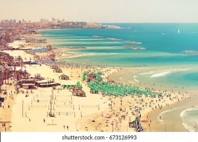 Mediterranean Seaside Of Tel Aviv. Beaches And Old Embankment (before Restoration) View. Ancient Arab City Of Jaffa Or Yafo On Horizon. Israel. Toned Colors Vintage Style Photo