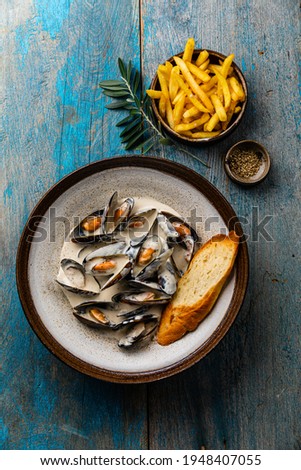 Similar – Image, Stock Photo Creamy mussels on wooden background